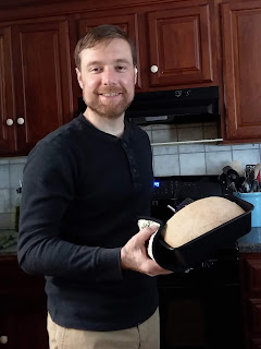 Chef David taking a loaf of bread out of the oven