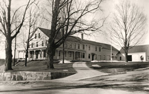 Whitcomb House, early 1900s, with wrap-around porch and attached barn that have been removed (photo courtesy of Arlene W. Perry)