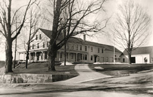 Photo courtesy of Arlene W. Perry Whitcomb House, early 1900s, with wrap-around porch and attached barn that have been removed (photo courtesy of Arlene W. Perry)