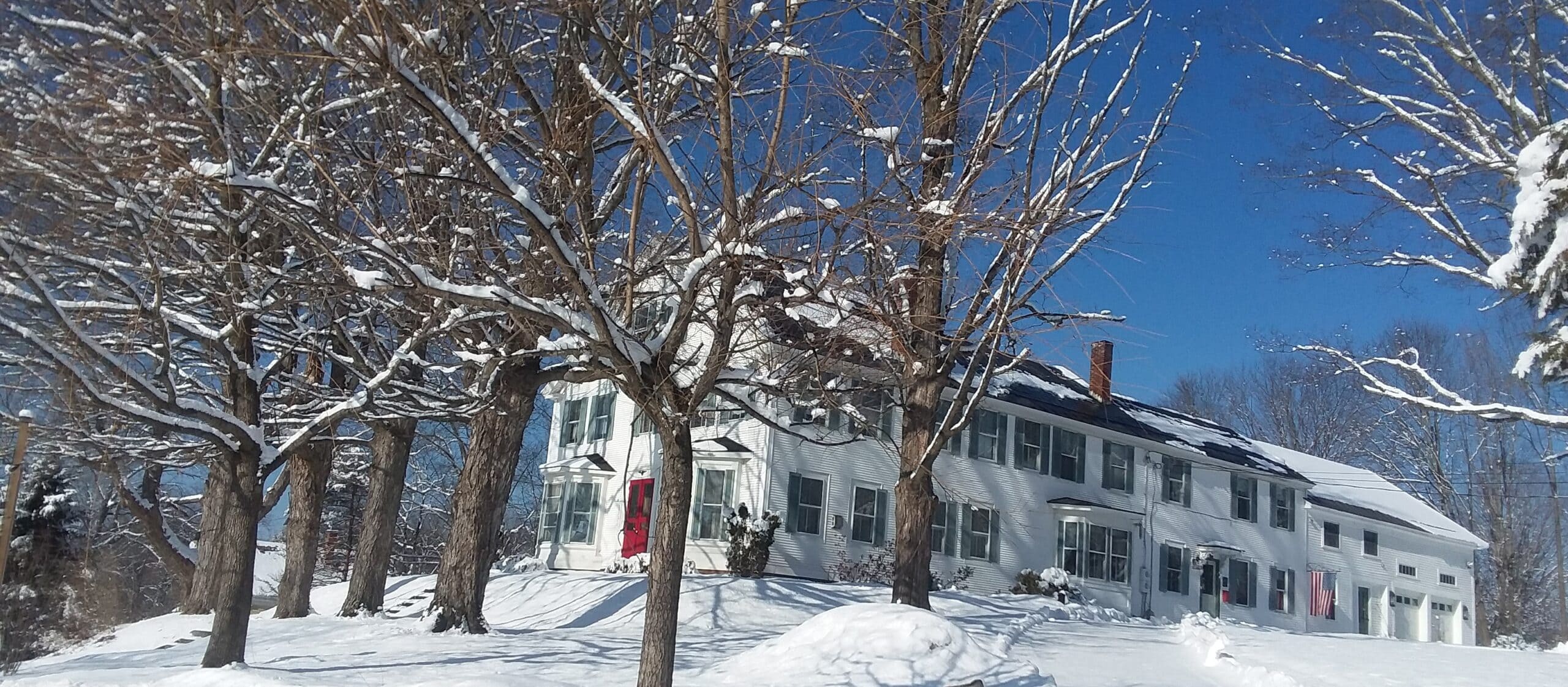 Winter inn with blue sky and snow