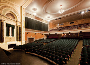 Beautiful theatre with rows of empty seats and the balcony, taken from the stage